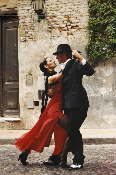 a man and woman dancing on the street