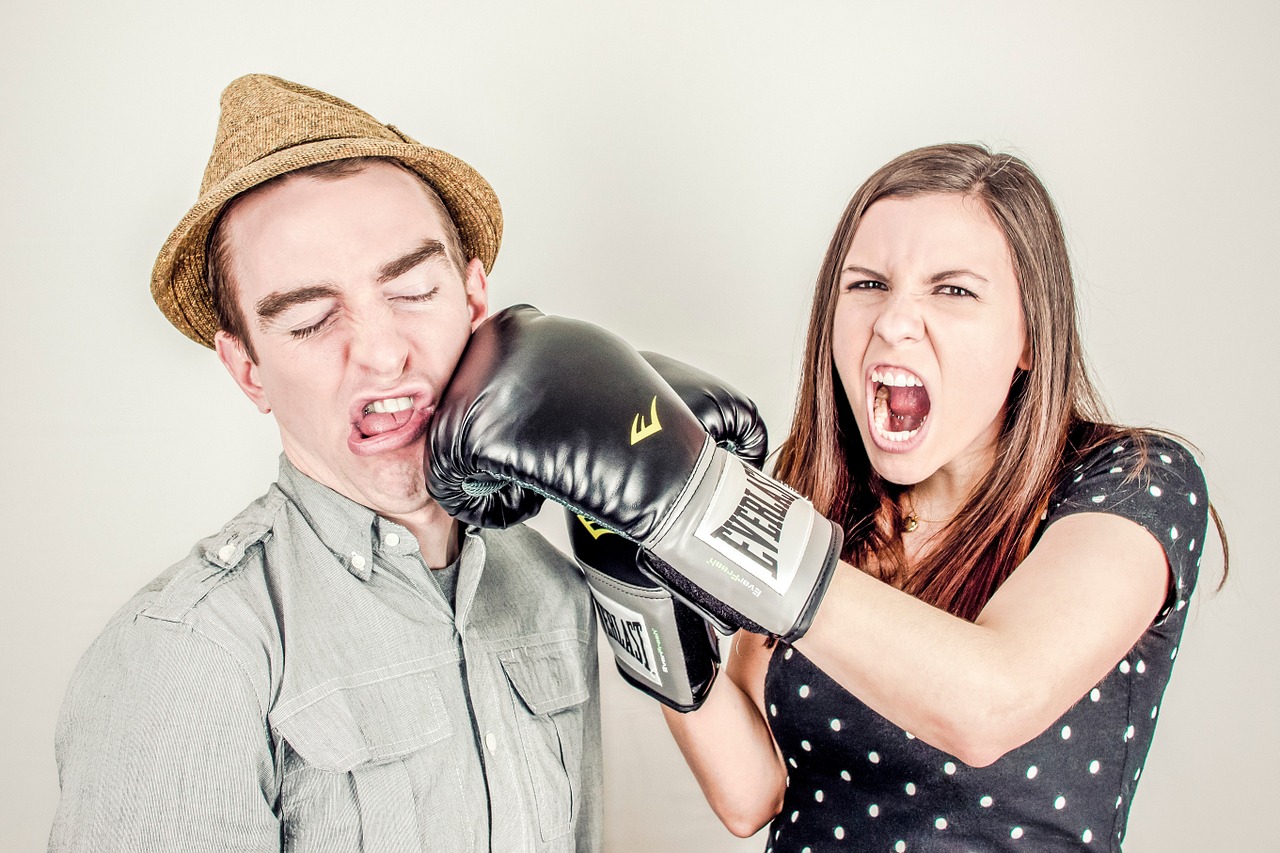 a man and woman wearing boxing gloves