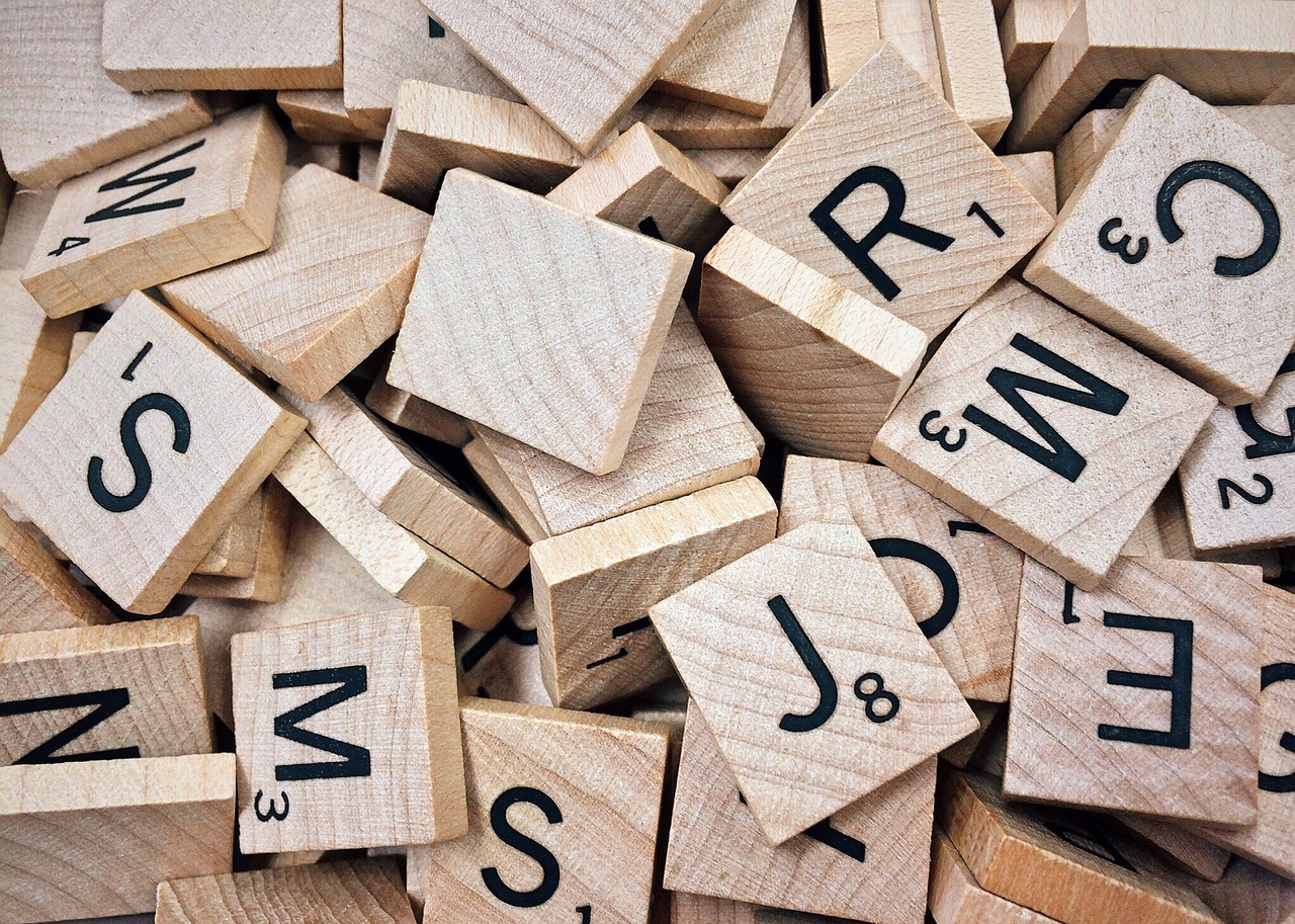 a pile of wooden tiles with letters