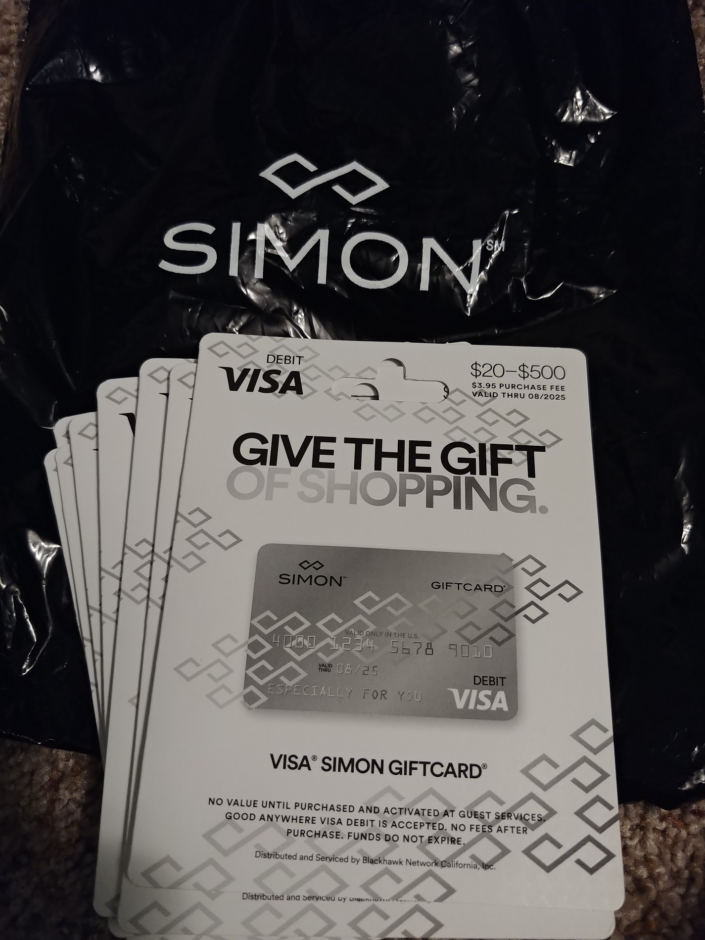 a group of gift cards on a black bag