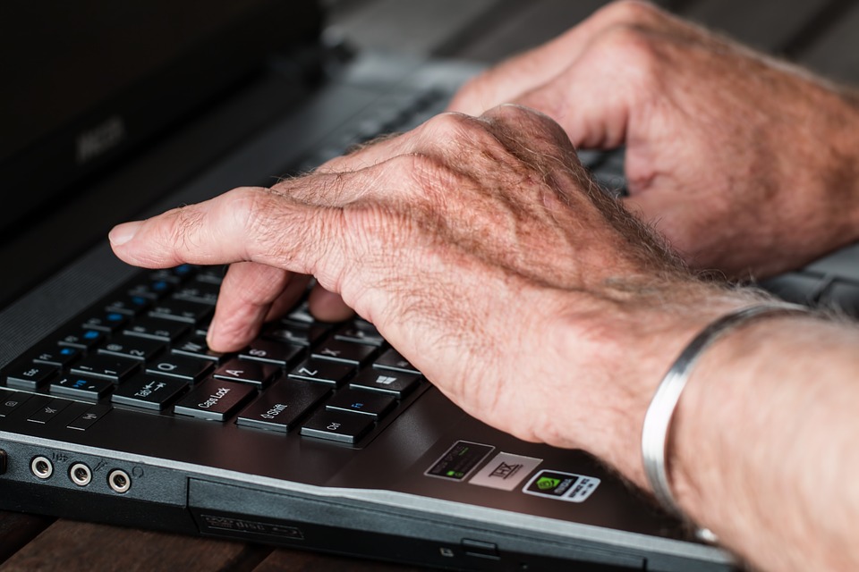 a person typing on a laptop