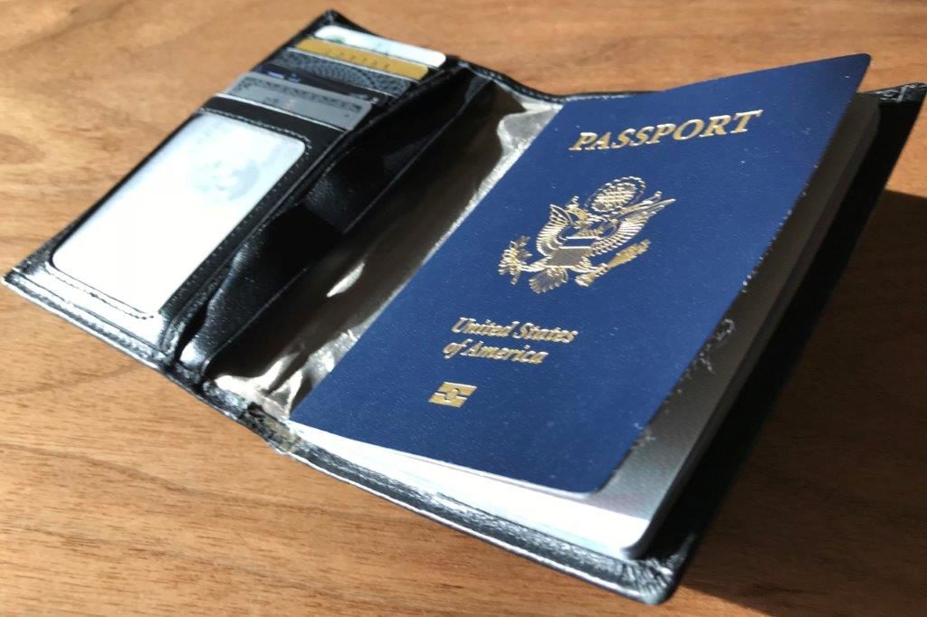 a passport and card holder on a table