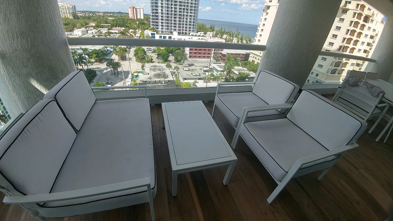 a group of chairs and a table on a balcony