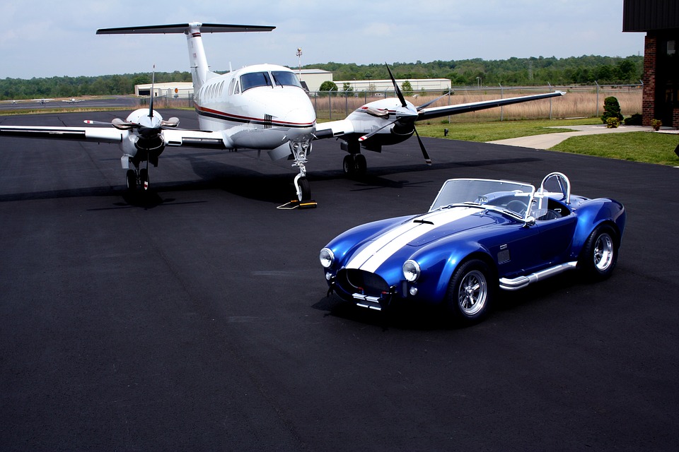 a blue car and a small airplane