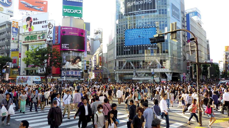 a crowd of people crossing a street