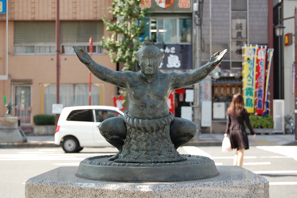 a statue of a man with his arms out
