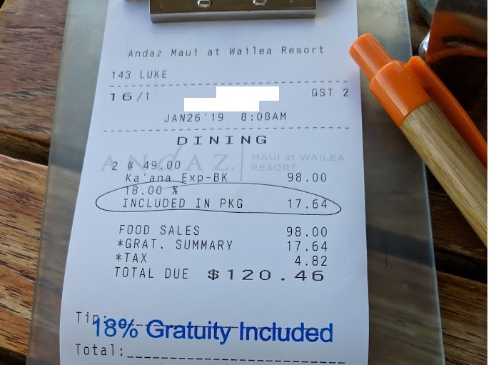 a paper receipt with a pen and a clip