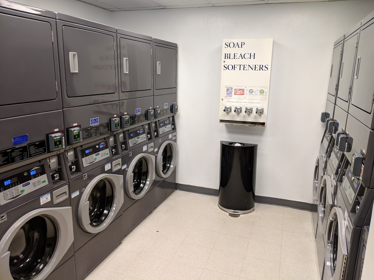 a laundry room with several washing machines