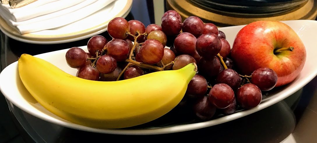 a banana and grapes on a plate