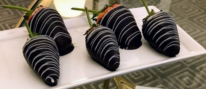 a plate of chocolate covered strawberries