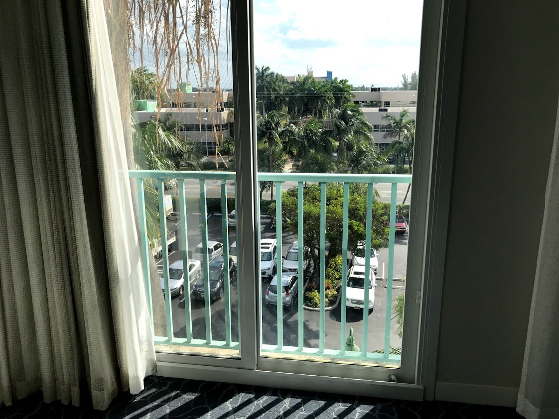 a balcony with a parking lot and cars