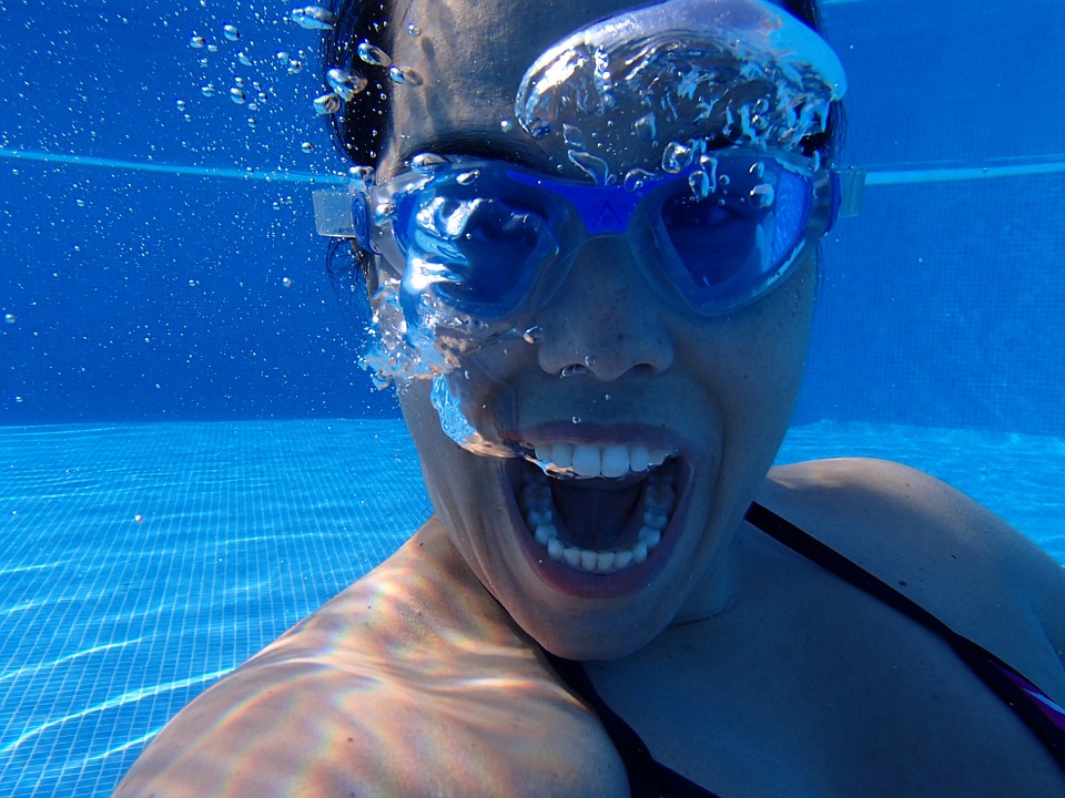 a woman wearing goggles and smiling
