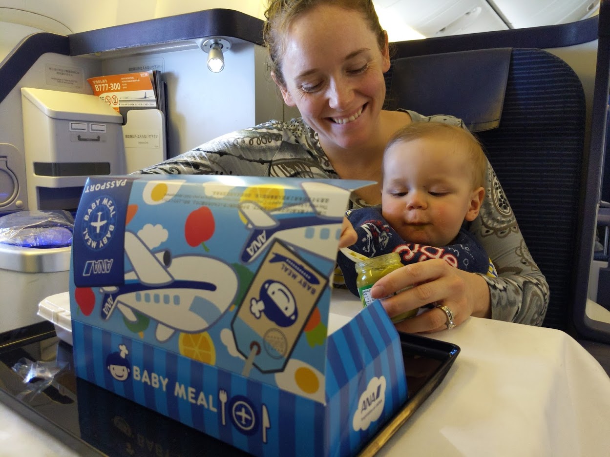 a woman and a baby eating from a box