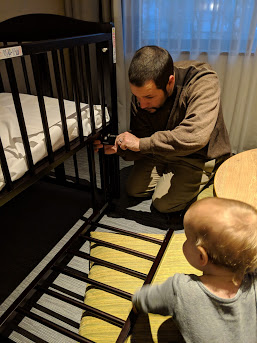 a man and baby looking at a crib