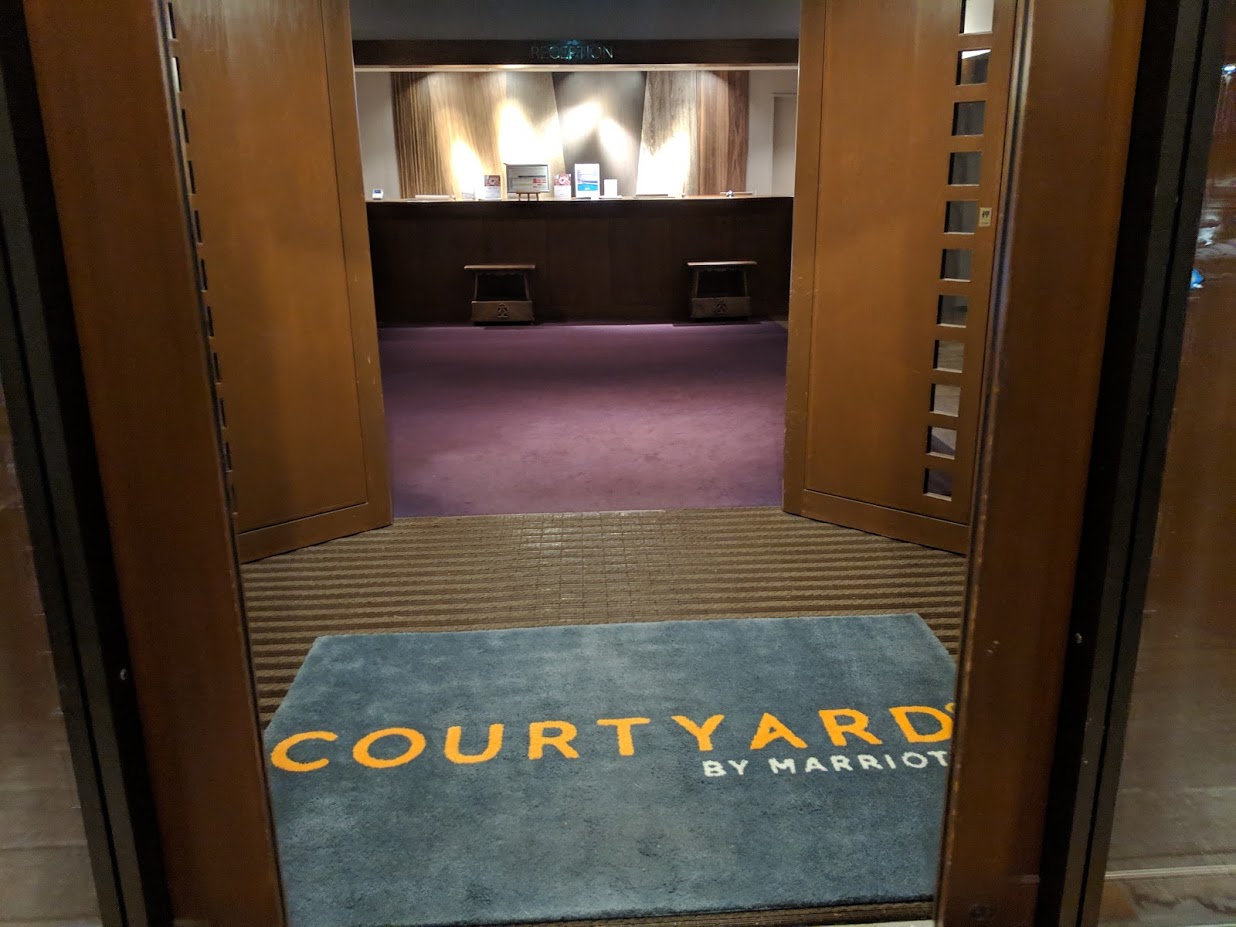 a door with a rug in front of a room