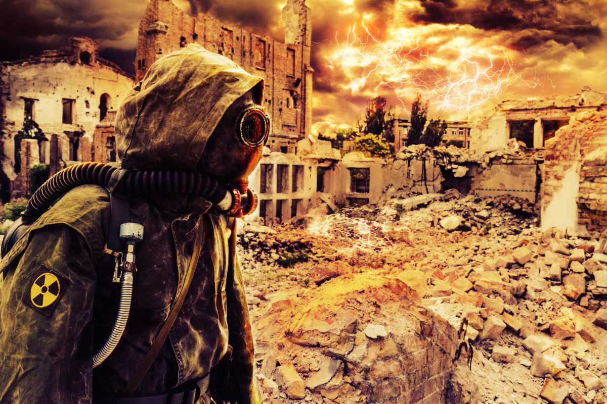 a person in a gas mask in a ruined city
