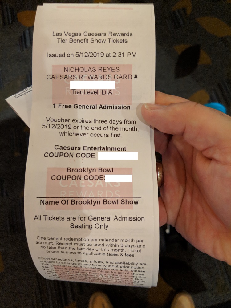a hand holding a paper ticket