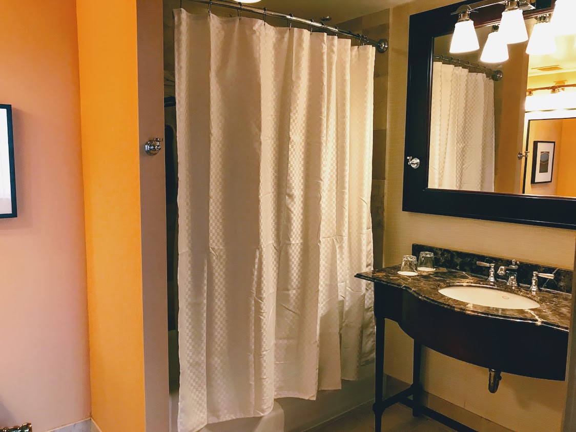 a bathroom with a sink and shower curtain
