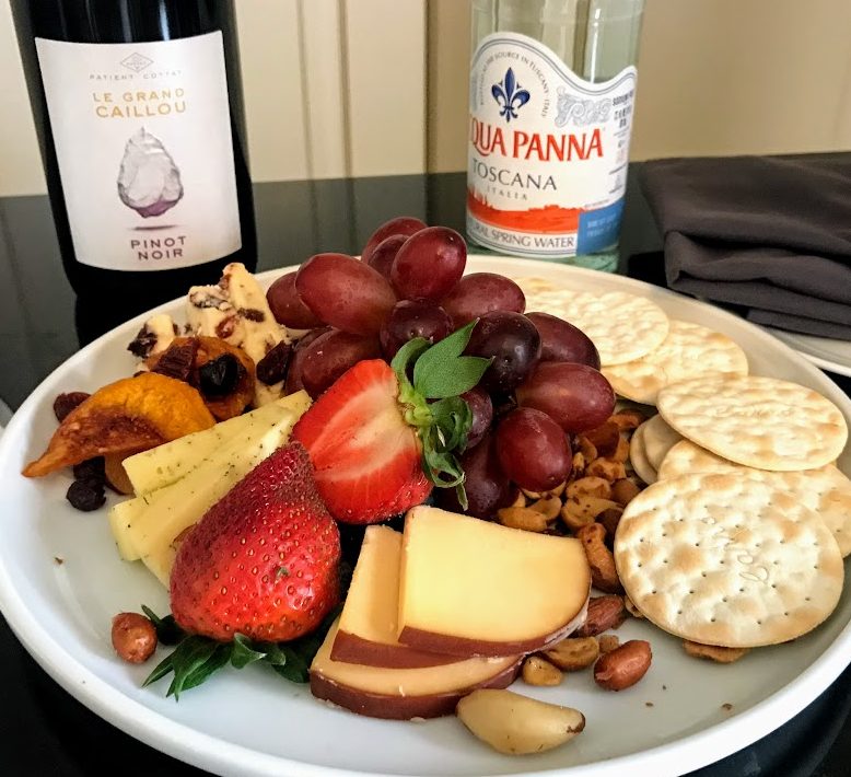a plate of food and a bottle of wine