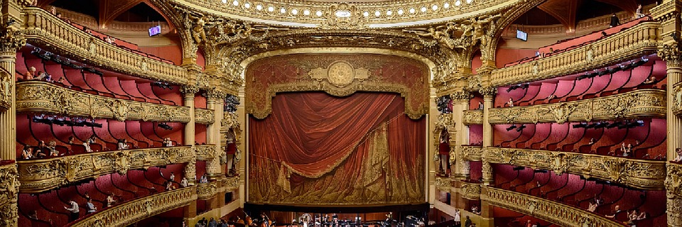 a large theater with a red curtain