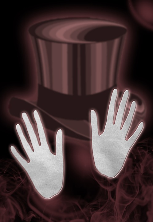 a pair of hands in a top hat