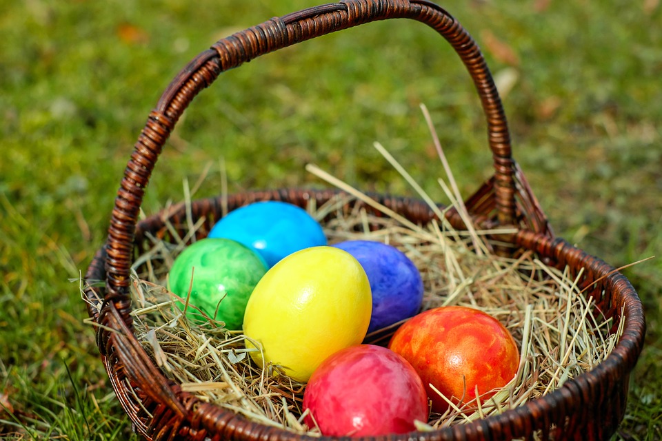 a basket with colorful eggs