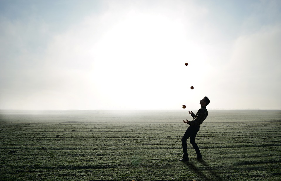 a man juggling balls in a field