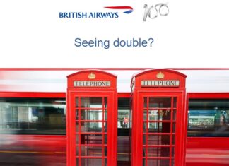 a red telephone booth next to a train