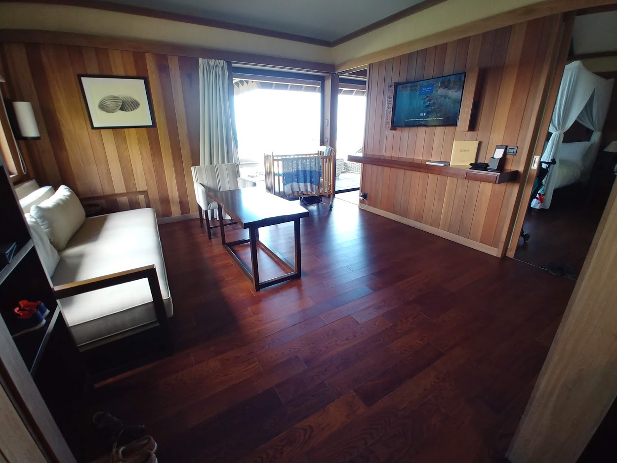 a room with wood paneling and a couch and a table