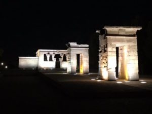 a stone structure with lights at night