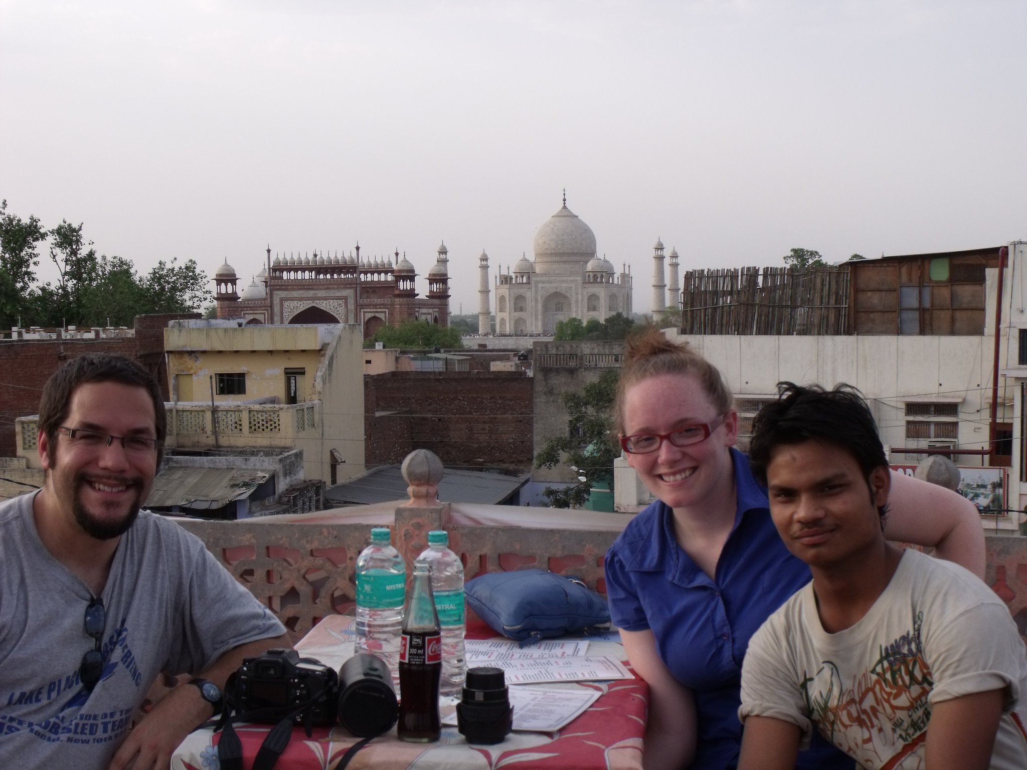 a group of people sitting at a table with a building in the background