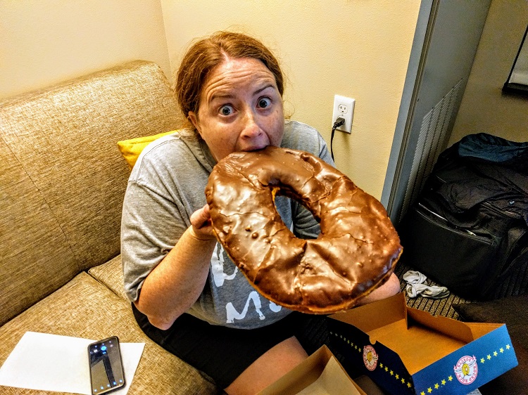 My wife enjoying a Texas-sized donut from Round Rock Donuts