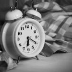a white alarm clock with bells