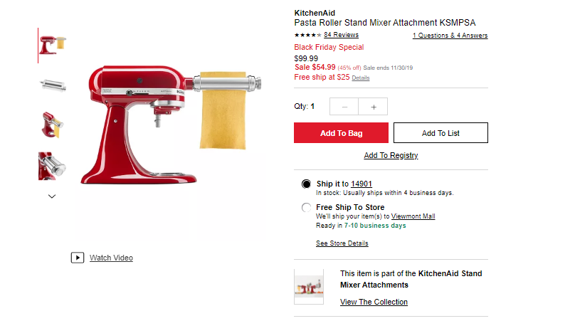 a red kitchen mixer with a roll of pasta