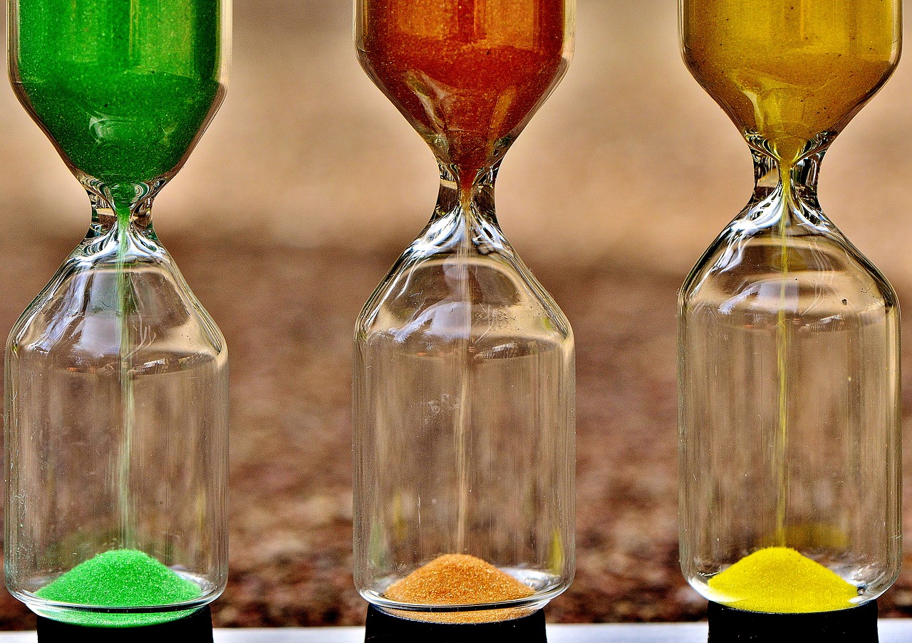 a group of hourglasses with different colored sand