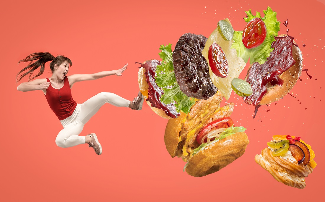 a woman kicking a hamburger