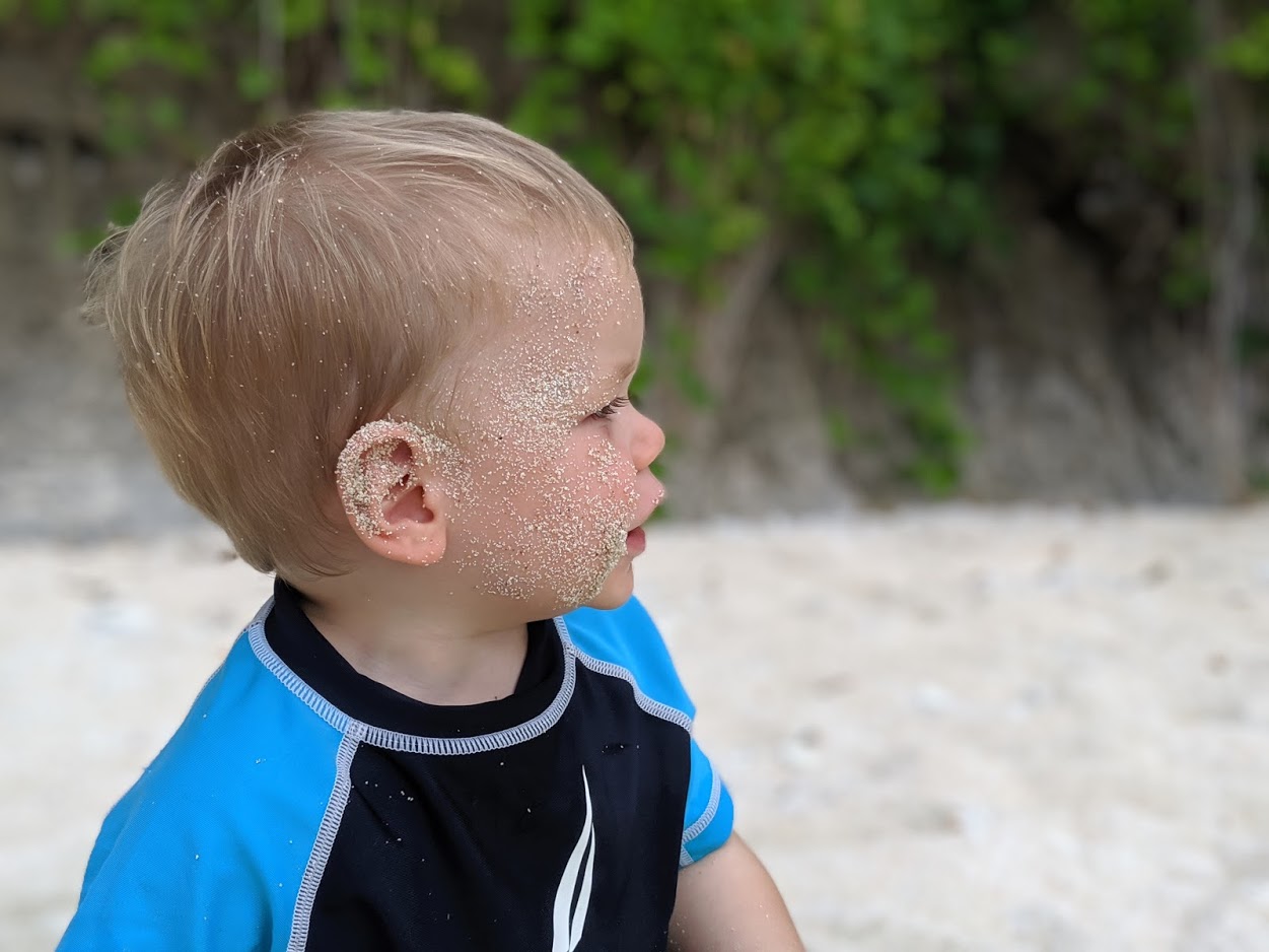 a child with sand on his face
