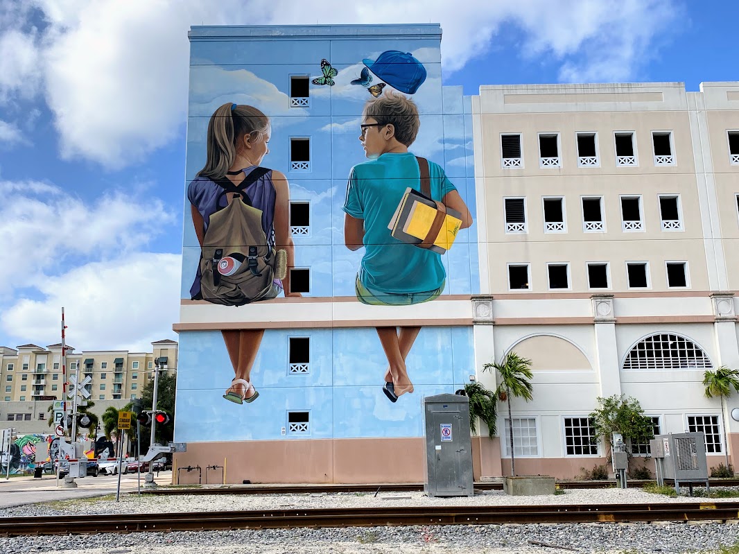 a mural of a couple of kids on a building