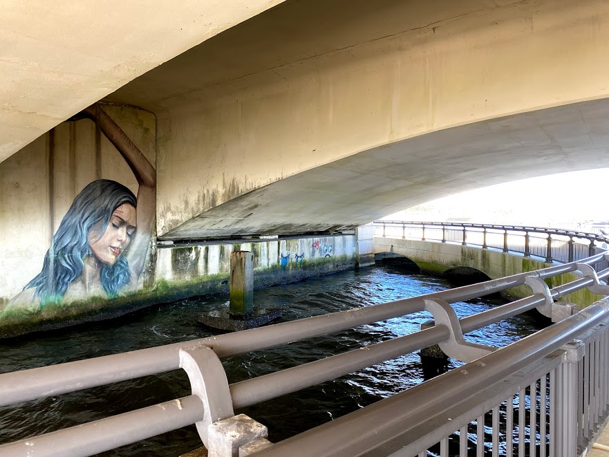 a bridge with a mural of a woman's face