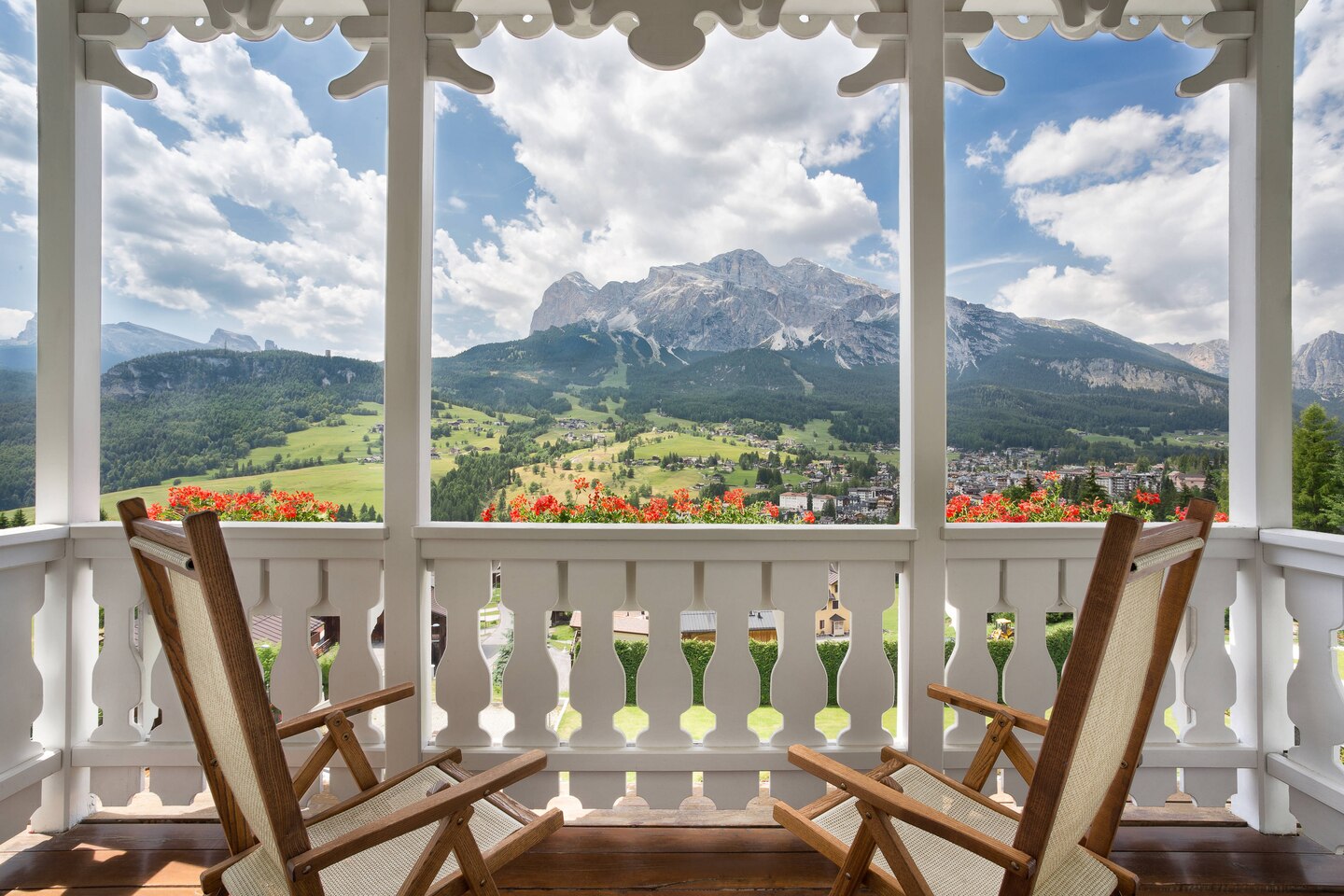 chairs on a porch overlooking a mountain range