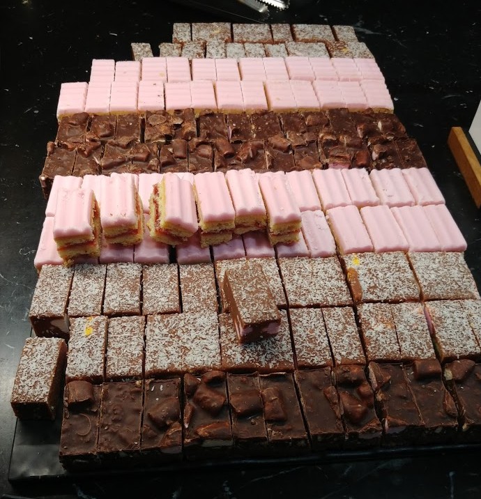 a group of chocolate and pink cakes