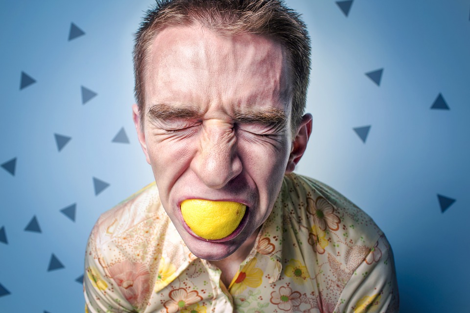 a man with lemon in his mouth