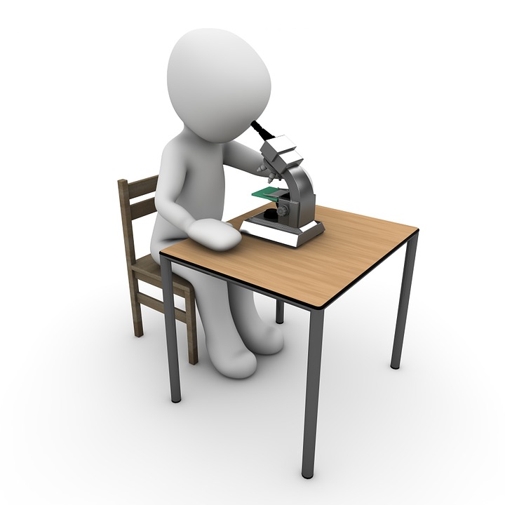 a cartoon character sitting at a desk with a microscope