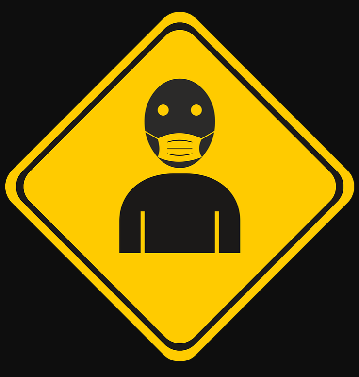 a yellow sign with a person wearing a face mask