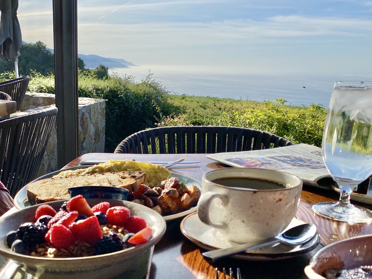 a table with food and a cup of coffee