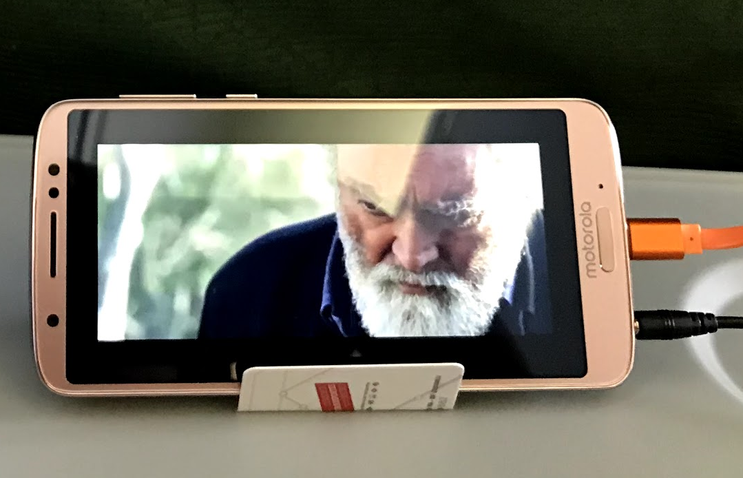 a cell phone with a screen showing a man's face