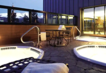 a hot tubs and a table on a patio
