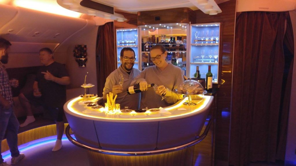 a man and woman standing at a bar