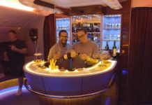 a man and woman standing at a bar