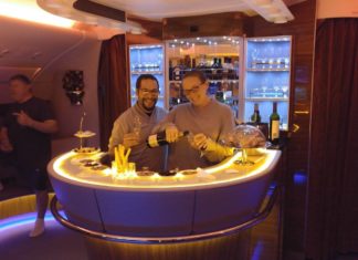 a man and woman standing at a bar